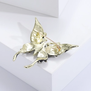 Detail view of the golden alloy butterfly brooch back featuring a secure pin clasp structure
