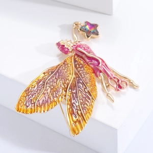 Broche fée dorée avec émail violet et ailes ambrées ornée d'une étoile en cristal pur