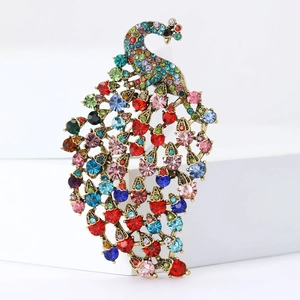 Macro shot of colorful rhinestones set on vintage gold peacock brooch feathers