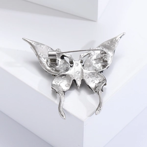 Detail view of the silver alloy butterfly brooch back with secure pin clasp mechanism