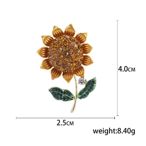 Sunflower brooch with orange rhinestones on gold alloy frame, 4cm height, white background