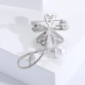 Detailed back view of a silver floral brooch showing the secure metal safety pin clasp