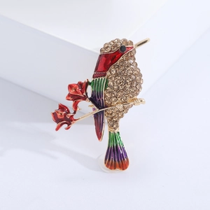 Broche colibri exquise avec cristaux champagne et détails en émail multicolore