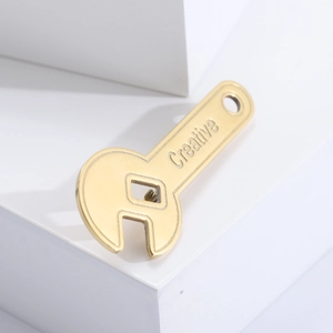 Macro detail of a creative gold wrench brooch with polished finish and creative engraving