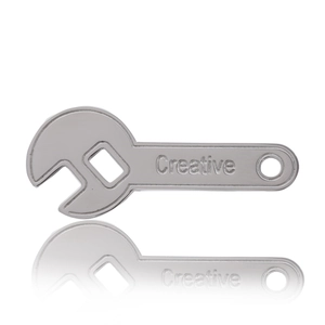 Polished silver stainless steel wrench brooch with Creative engraving on white background
