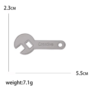 Creative wrench-shaped stainless steel brooch for women featuring engraved text and dimensions