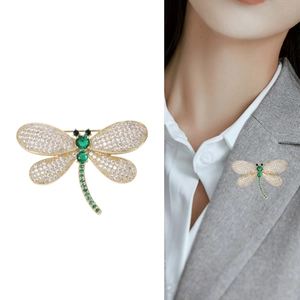 Elegant gold dragonfly brooch with green gemstones and white zircon pave setting