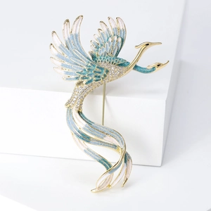 Macro detail of Phoenix brooch featuring blue-white gradient enamel and zircon pavé