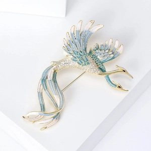 Elegant gold phoenix brooch with blue enamel gradient wings and sparkling zircons