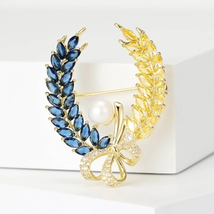 Vintage wheat wreath brooch with blue and yellow stones and a white pearl accent