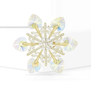 Elegant snowflake brooch with blue heart crystals and gold plating on white base
