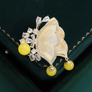 Elegant gold butterfly brooch with yellow mother-of-pearl wings and zircon stones