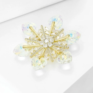 Austrian crystal snowflake brooch with blue heart crystals on a white pedestal