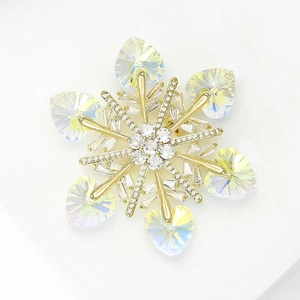 Elegant gold snowflake brooch featuring heart-shaped crystals and shimmering zircons