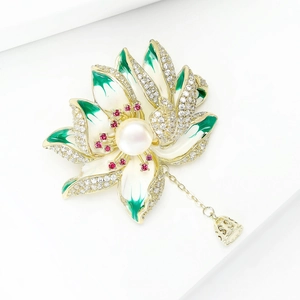 Elegant lotus flower brooch with white enamel petals, green accents and a center pearl
