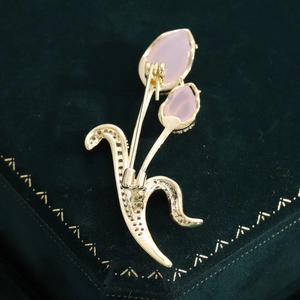 Detailed back view of a gold tulip brooch featuring a secure pin clasp and pink stones