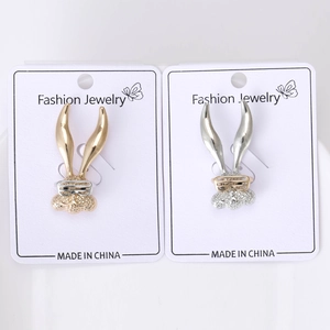 Close-up of gold and silver rabbit brooches with sparkling crystals and cute glasses