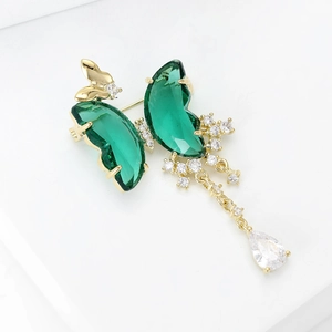 Luxury butterfly brooch with green crystals and long tassel pendant on gold base