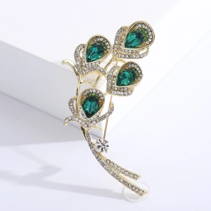 Elegant gold feather brooch with emerald green teardrop crystals and micro diamonds