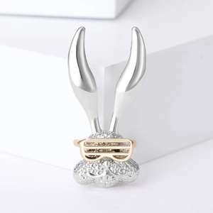 Detail of bunny charm with sparkling white zircons and golden glasses feature