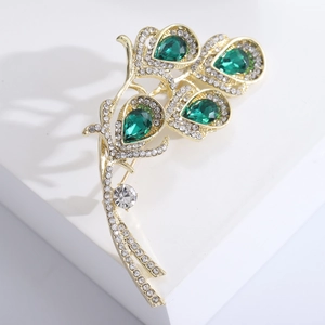 Vintage emerald calla lily brooch with gold metal base and sparkling crystal accents