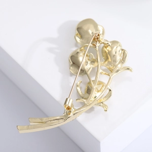Detail of the golden calla lily brooch back with a secure horizontal safety pin clasp