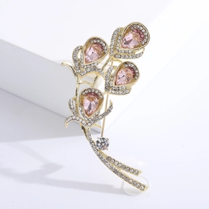 Elegant gold-plated brooch with pink teardrop crystals and sparkling white rhinestones