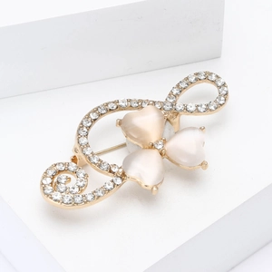 Elegant gold musical note brooch with heart cat eye stones and sparkling rhinestones