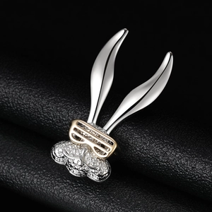 Detail of silver bunny brooch with gold glasses and micro-pave crystals on black leather