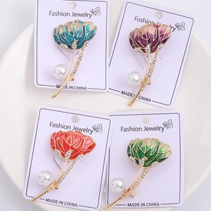 Detailed close-up of tulip flower brooches with enamel petals and sparkling rhinestones