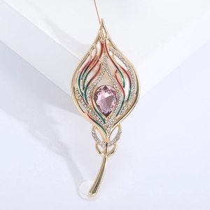 Fashionable golden feather brooch with pink crystal and colorful enamel inlay details