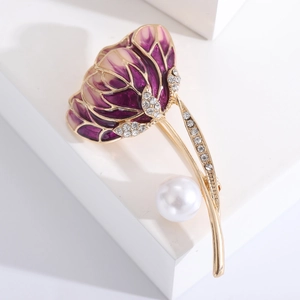 Detail of purple flower brooch with white enamel, crystal leaves and a large pearl