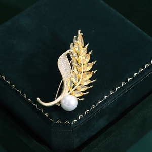 Elegant gold wheat brooch with yellow zircons and pearl on green velvet box