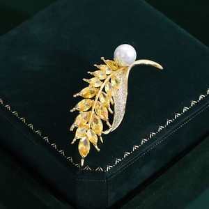 Elegant wheat ear brooch with yellow marquise gems and pearl on green velvet box