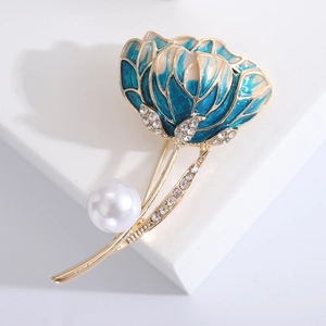 Detailed close-up of blue enamel flower brooch with rhinestones and a white pearl