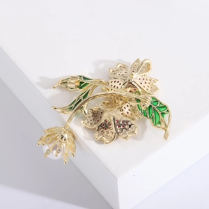 Luxury floral zircon brooch with green enamel leaves, red crystals and a white pearl drop