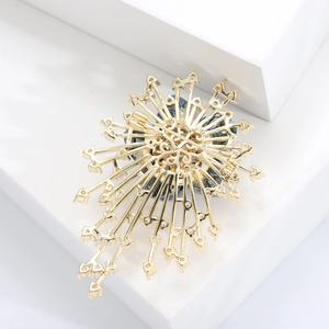 Detail view of the gold brooch back showing secure pin clasp and filigree structure