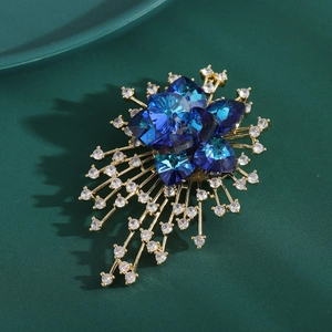 Elegant gold flower brooch with navy blue heart crystals and sparkling cubic zirconia stars