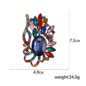 Broche en cristal vintage luxueuse avec strass multicolores et gemme bleue