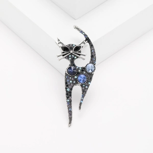 Cute cat shape brooch with blue crystals and rhinestones on a minimalist white base