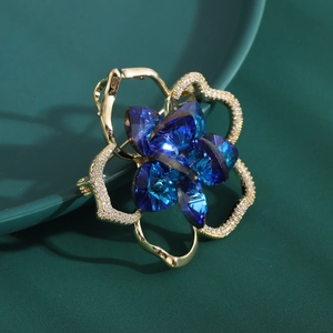 Elegant gold camellia flower brooch with deep blue crystal and zircon accents for coats