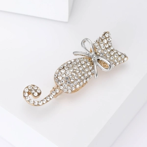Close-up of sparkling cat brooch featuring gold-plated metal and intricate rhinestone inlay