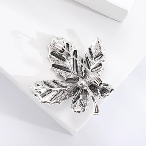 Detailed back view of leaf brooch showing leaf veins and sturdy safety pin closure