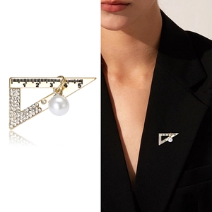 Creative triangle ruler brooch with rhinestones and pearl pendant on a black blazer