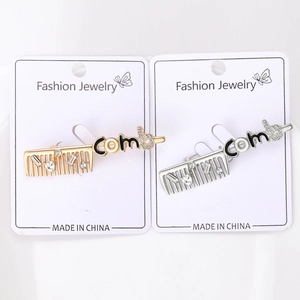 Detail of comb shaped brooches with inlaid rhinestones in gold and silver finish