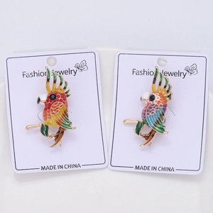 Detailed close-up of colorful enamel parrot brooches with fine gold alloy craftsmanship