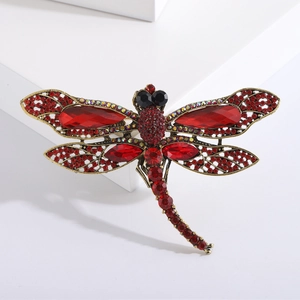 Exquisite red dragonfly brooch with rhinestones and gems on a vintage gold base