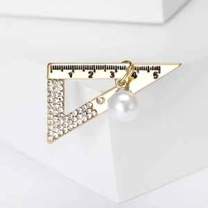 Creative triangle ruler brooch in gold with rhinestones and a white hanging pearl