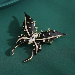 Elegante spilla a farfalla nera con finitura dorata e micro-pavé di zirconi cubici