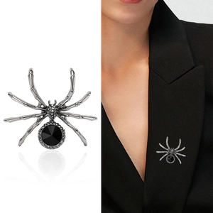 Gothic silver spider brooch with black gemstone and crystals on a male suit lapel